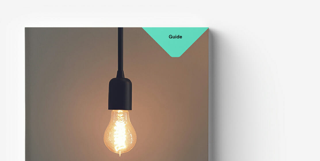 A lit light bulb hanging from a black fixture against a muted background, with a green corner tab labeled "Guide" symbolizes innovative ideas in rapidly changing markets.