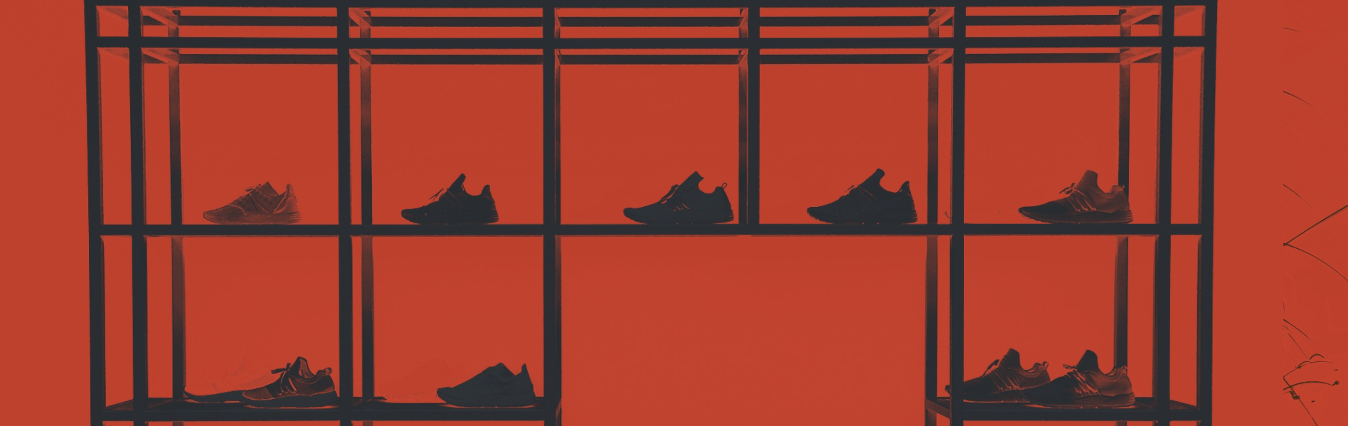 Shoes lined up in shelves with red background