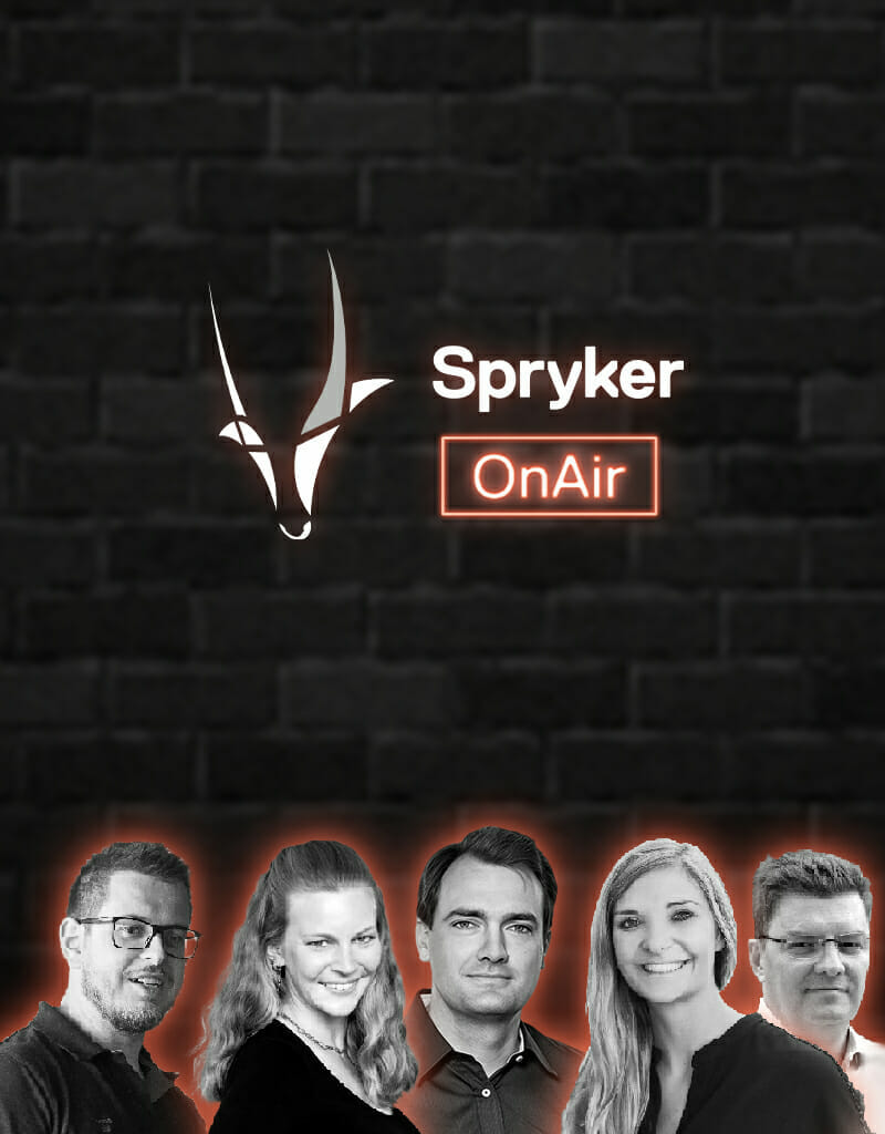 Five people are standing in front of a black brick wall with the Spryker logo and "OnAir" sign above them.