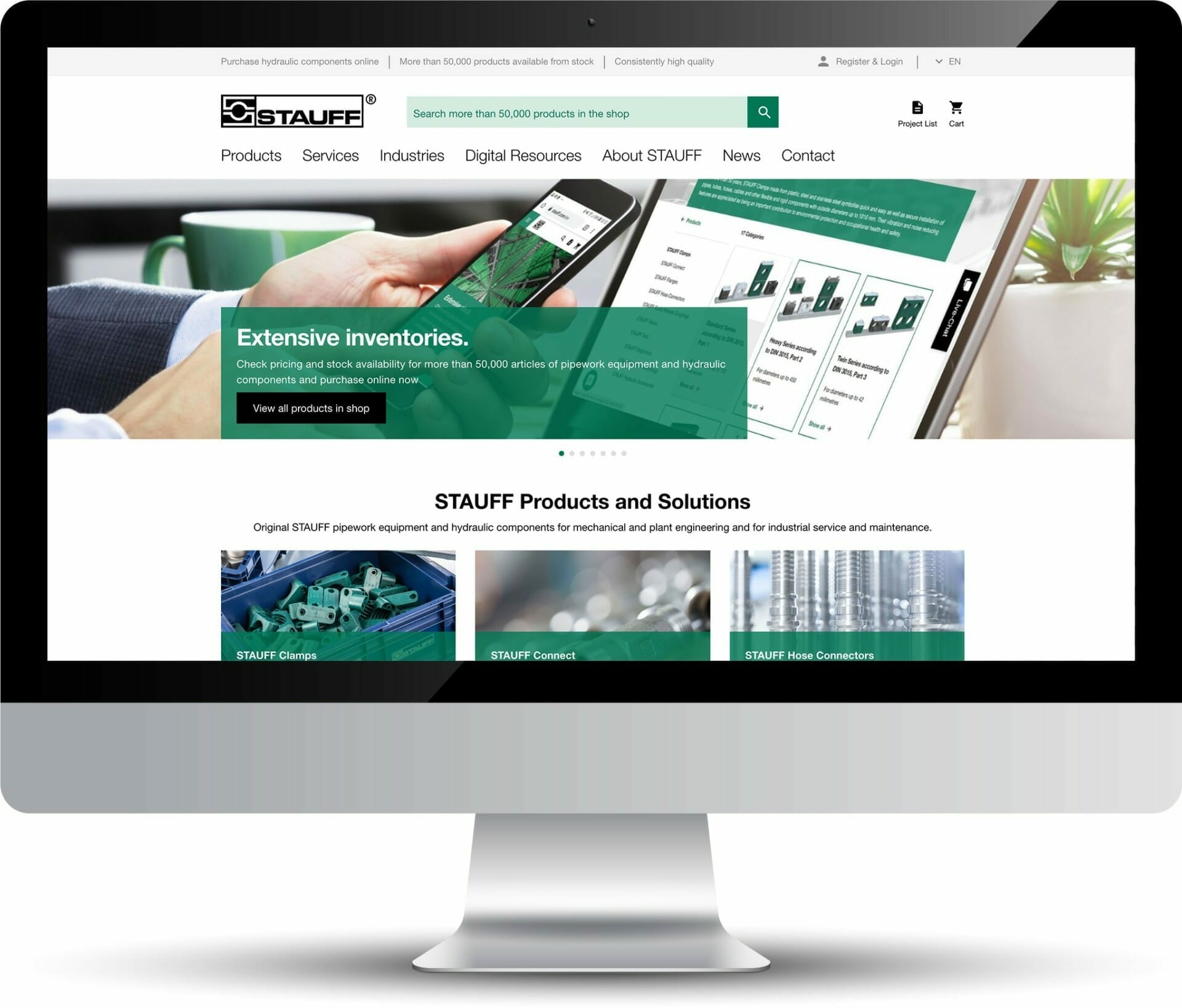 A computer screen displays the STAUFF website, showcasing their hydraulic components and solutions with sections for products, services, industries, digital resources, and company information by Stauff.