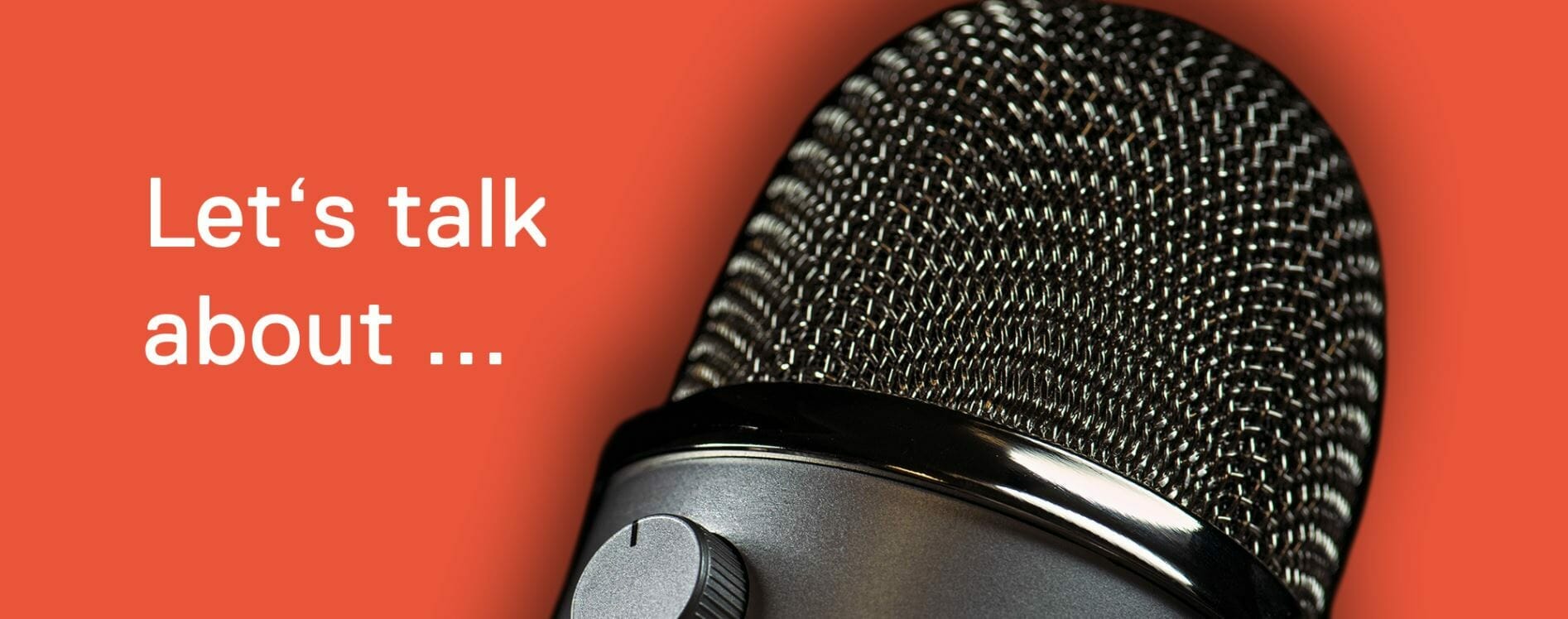 Close-up of a microphone against a red background with the white text "Let's talk about Internationalization..." on the left side.