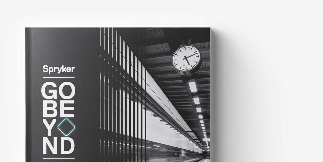 A book cover titled "Go Beyond: 7 Concepts" by Spryker featuring a black and white photograph of a train station with a clock.
