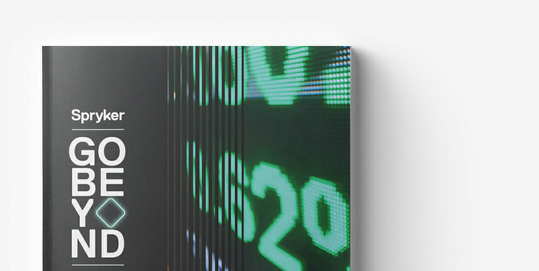Close-up of a book with the title "Go Beyond" by Spryker displayed on the cover, next to an image of a digital screen showing the number 20, highlighting insights on B2B pricing strategies.