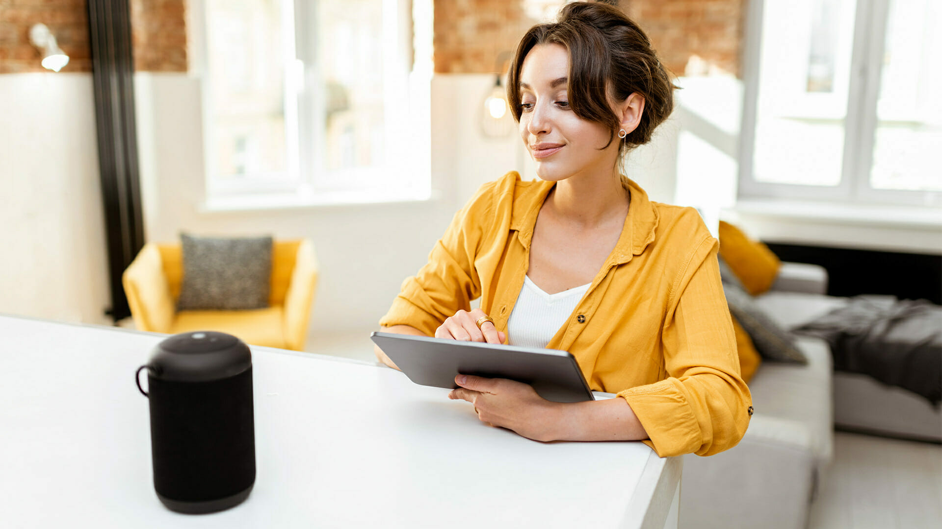 Woman using tablet and voice assistant