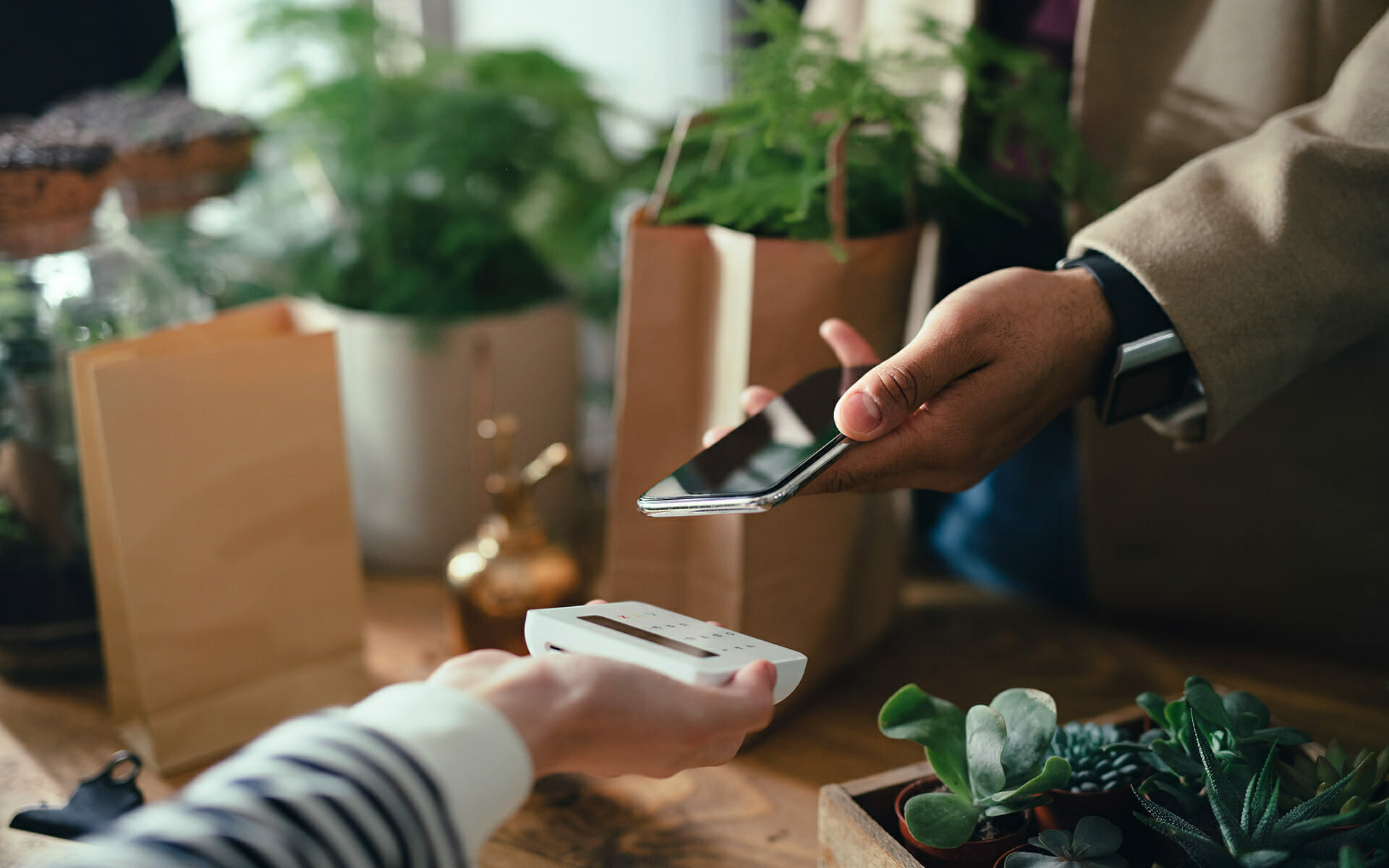 Unified Commerce - customer paying in-store with a smartphone