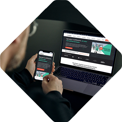 A person is viewing the Spryker Careers website on both a smartphone and a laptop. The site focuses on providing digital commerce solutions.