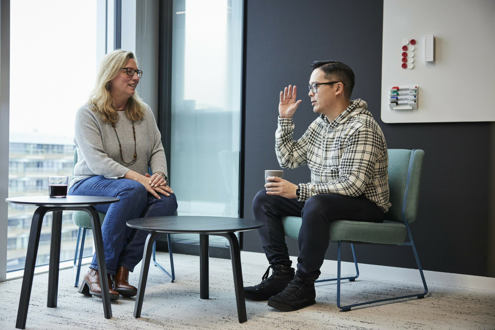 Two Spryker employees discussing in the office