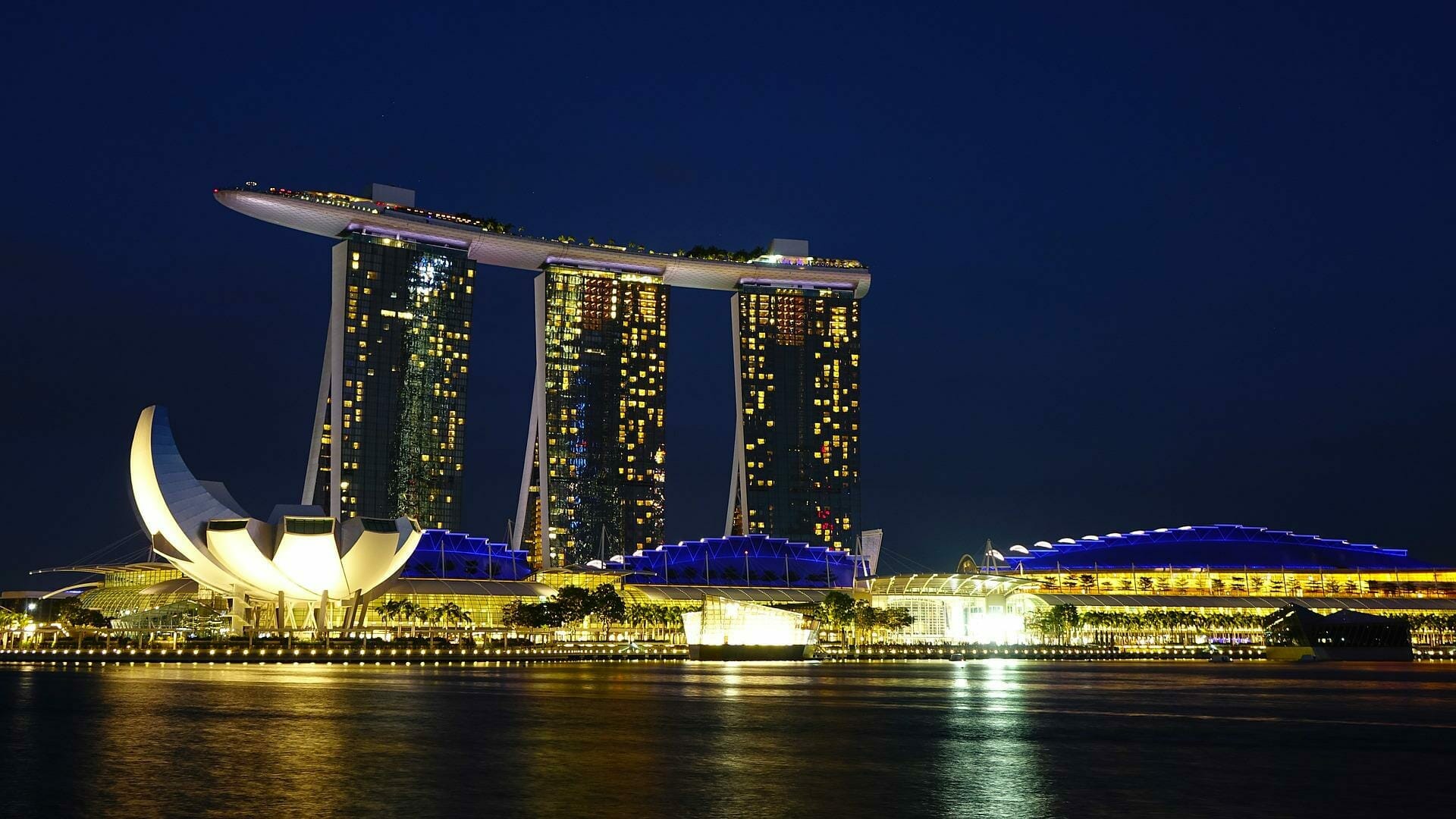 Night view of Marina Bay Sands in Singapore, featuring its distinct three-tower structure and illuminated surroundings, epitomizing the vibrant energy of e-commerce hubs in Asia.