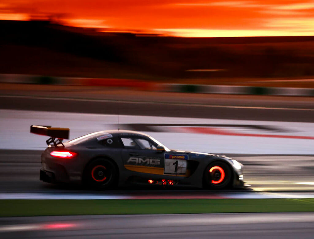 Sports car racing during sunset